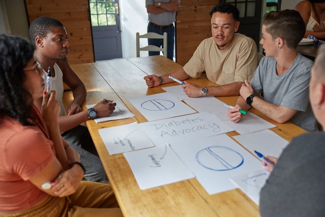 Diverse group of Belgian marketing professionals discussing strategy around a table